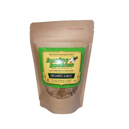 Brown craft resealable bag of dog cookies with a green and yellow label and a clear window showing brown cookies.