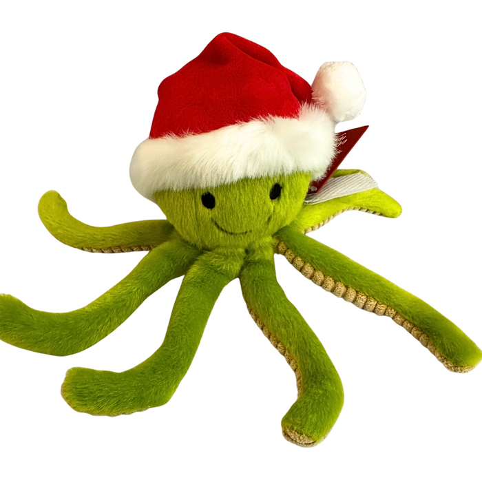 A bright green octopus with lighter green corduroy texture fabric on the underside of its tentacles. It's has two eyes and smile stitched on with black thread. It's wearing a bright red Santa hate with white fluffy trim and a white pompom on the end.