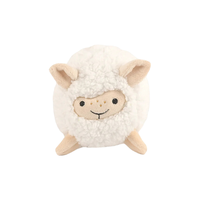 Front facing view of a dog toy shaped like a round woolly sheep. It has a white fleece and beige ears and legs, as well as a beige face. It has two sewn on black eyes and some freckles on its nose, which is embroidered on in a semi circle.